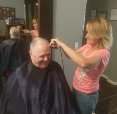 A resident getting a haircut in the common area