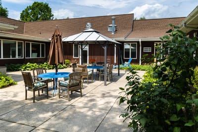 Outdoor courtyard with dining furniture and gazebo at Winter Growth