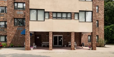Exterior view of the facility entrance with seating