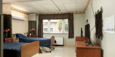 A well-furnished resident room with two beds
