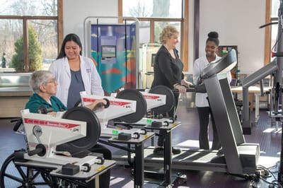 Residents engaging in therapy exercises with staff