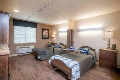 A well-furnished shared resident room with two beds.