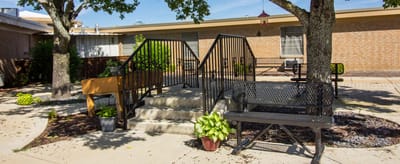 Outdoor seating area with stairs and trees