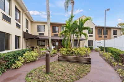Residents enjoying a garden area in a senior living facility