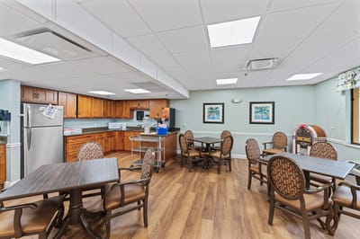 Bright kitchen area with dining tables and cabinets