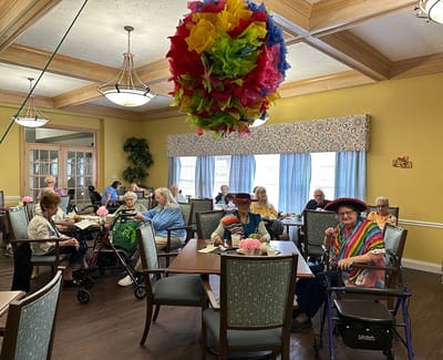 Residents enjoying a festive meal in the dining room