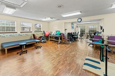 Therapy room with fitness equipment and chairs