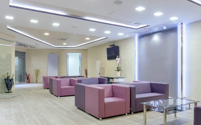 Interior view of a modern lounge with purple seating
