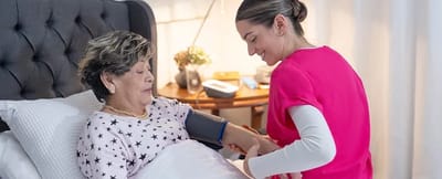 Nurse taking blood pressure of a senior resident