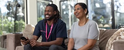 Staff member and resident enjoying time together in a lounge