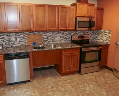 Modern kitchen interior with wooden cabinets and appliances