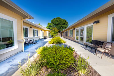 Outdoor walkway with landscaped garden and seating