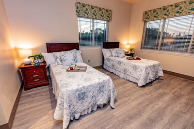 Brightly decorated shared resident room with two beds