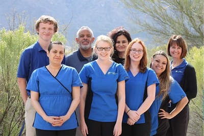 Group of staff members posing outdoors in uniforms