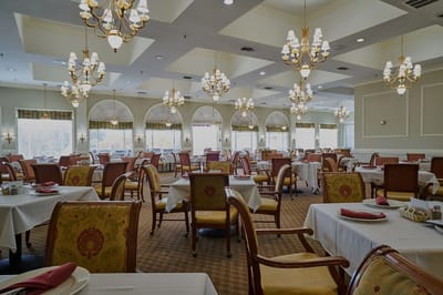 Elegant dining room with chandeliers and tables