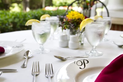 Dining table set with glasses and flowers