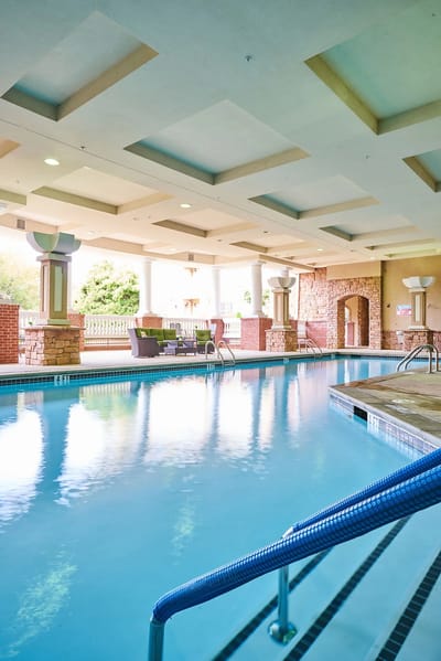Indoor swimming pool area with lounge seating