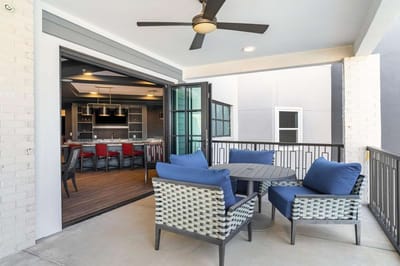 Outdoor seating area with view into a dining space