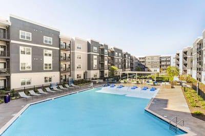 View of the outdoor pool area with surrounding apartments