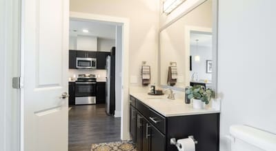 Modern bathroom with a view into the kitchen area