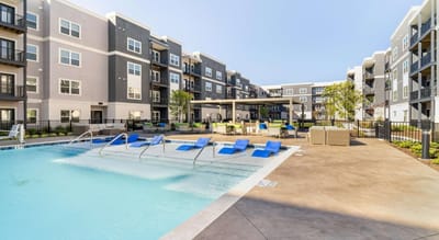 Outdoor pool area with seating and lounge chairs