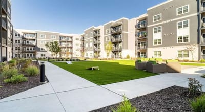 Outdoor green space with seating in the facility courtyard