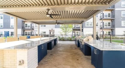 Outdoor kitchen area with grills and seating