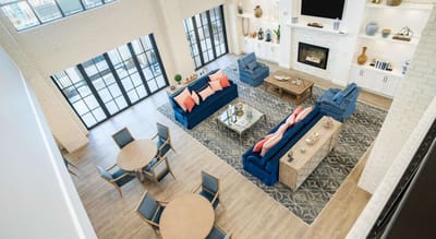 Bright common area with seating and a fireplace