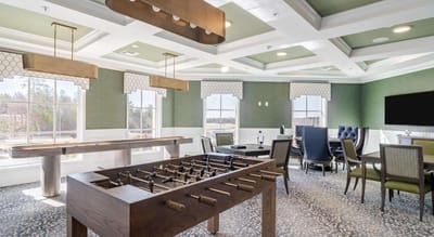 Bright community common area with game tables