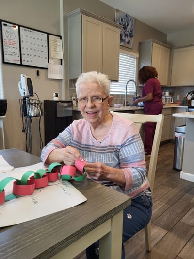 Resident engaged in an activity at a facility interior