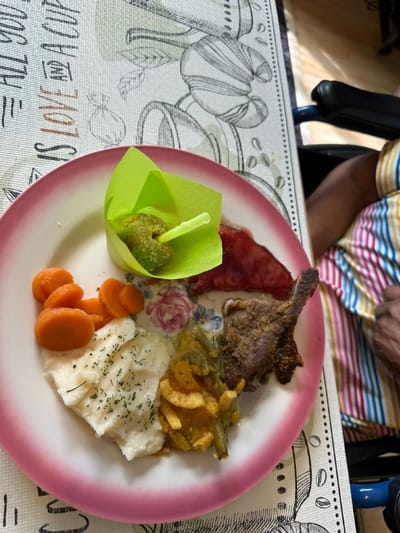 A plated meal with fish, vegetables, and dessert