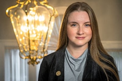 Portrait of a staff member in a well-lit interior space.