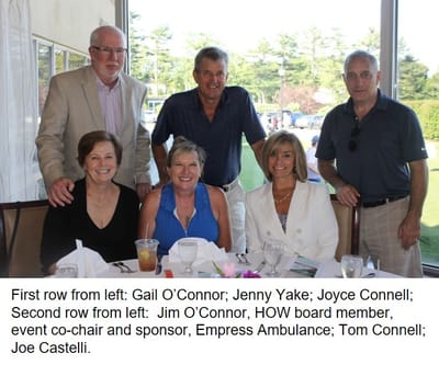 Group of six people at a dining table celebrating an event.