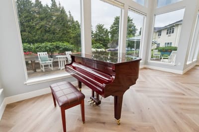 Piano in a common area with large windows