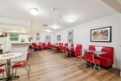 Bright and inviting dining area with red booths