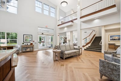 Bright interior lobby with seating and a staircase