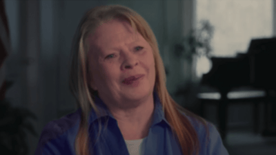 A woman smiling during an interview indoors.