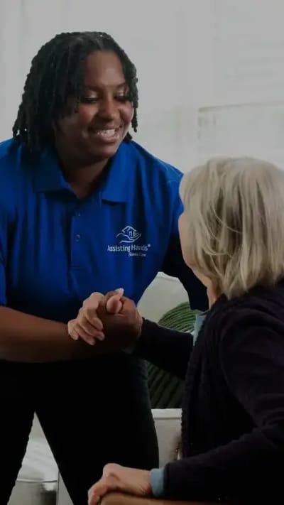 Caregiver interacting with a senior resident indoors