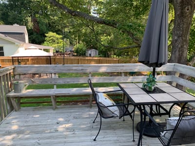 Outdoor deck with seating area in a serene setting