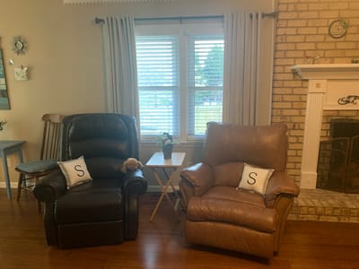 Cozy living room with reclining chairs and decorative pillows