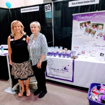 Staff members at a senior care event booth