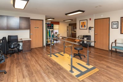 Therapy area with parallel bars in a rehabilitation room