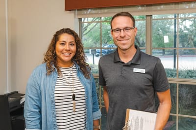 Staff members smiling in a common area