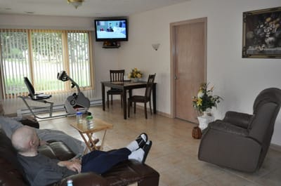 Residents relaxing in a common area with TV