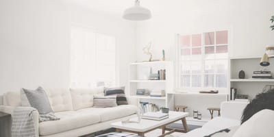 Bright common area with white furniture.