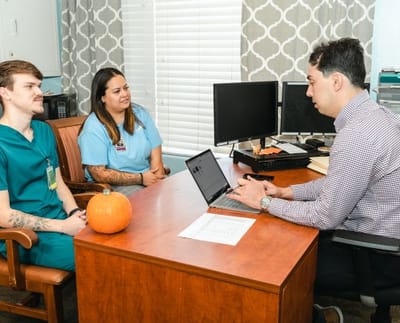 Staff meeting in an office setting with residents