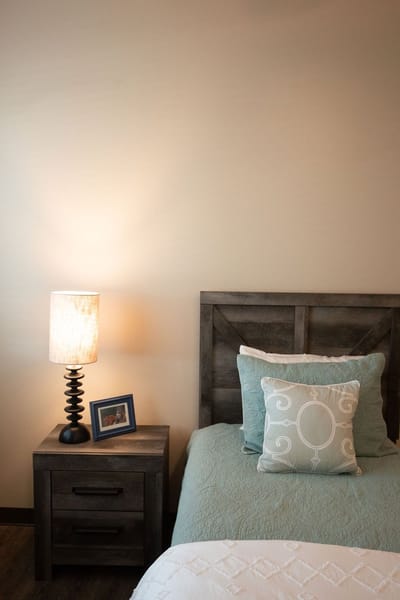 Cozy resident room with a bed and lamp