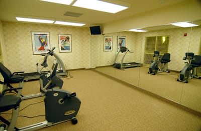 Interior view of a small gym with exercise equipment