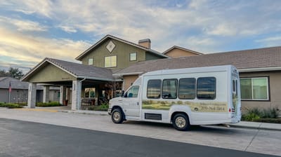 Facility entrance with shuttle bus parked outside