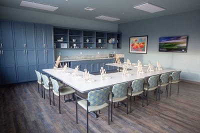 Bright activity room with easels set up for painting